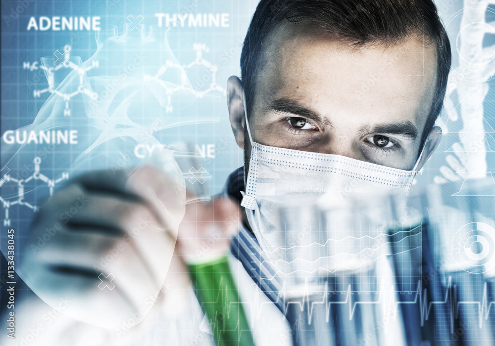 Portrait of concentrated male scientist working with reagents in laboratory