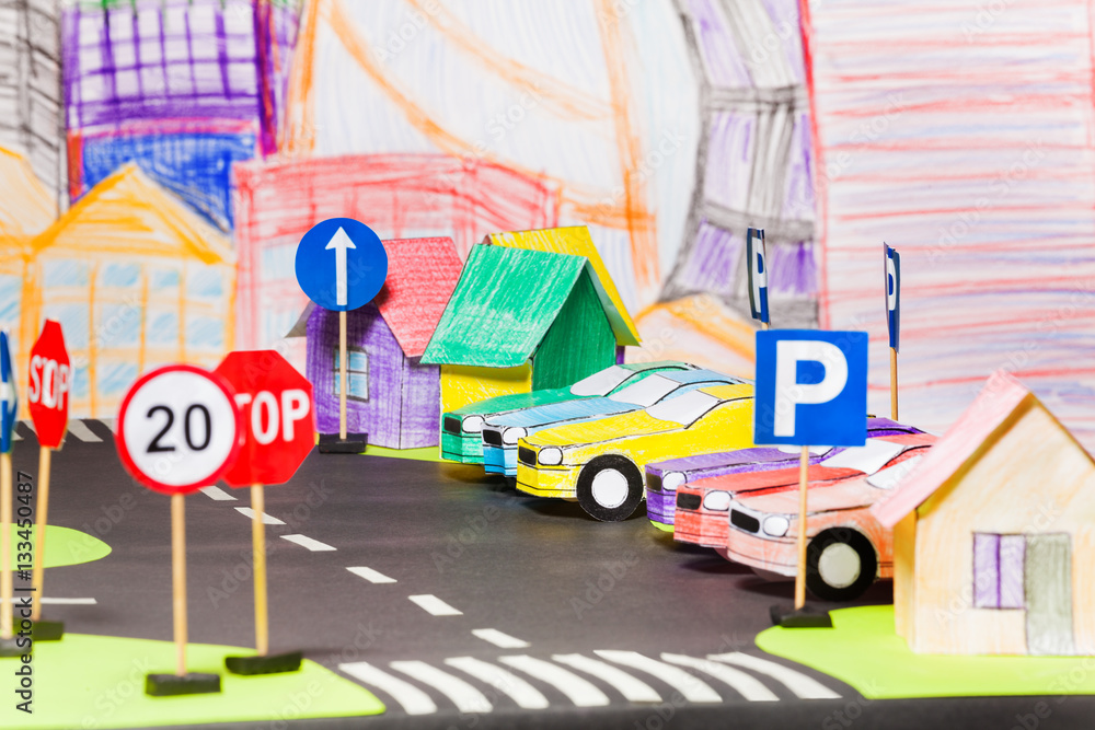 Models of paper cars at the parking in toy city