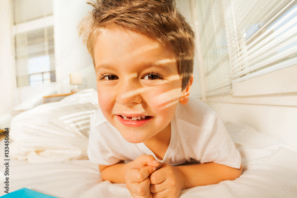 Cute boy resting at home in sunny morning