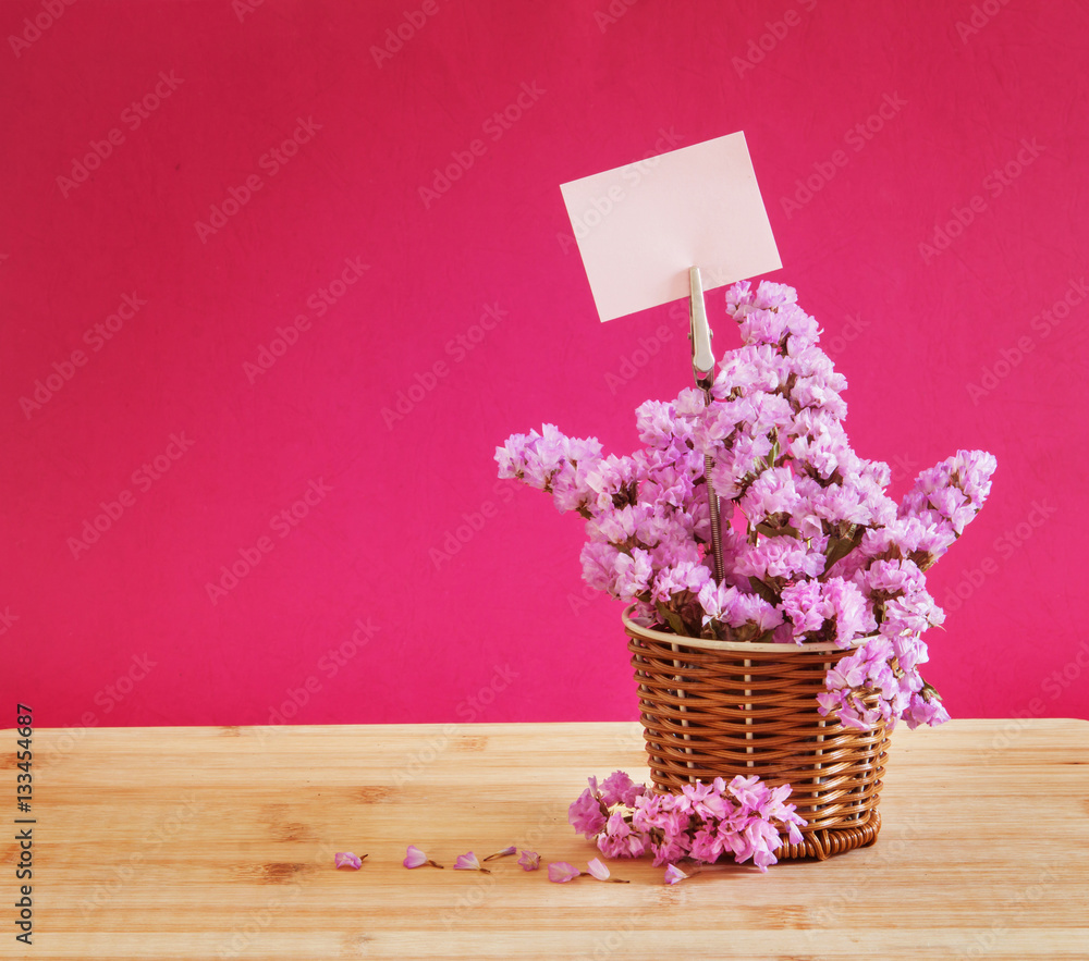 sweet statice flower in basket with blank paper label on red pin