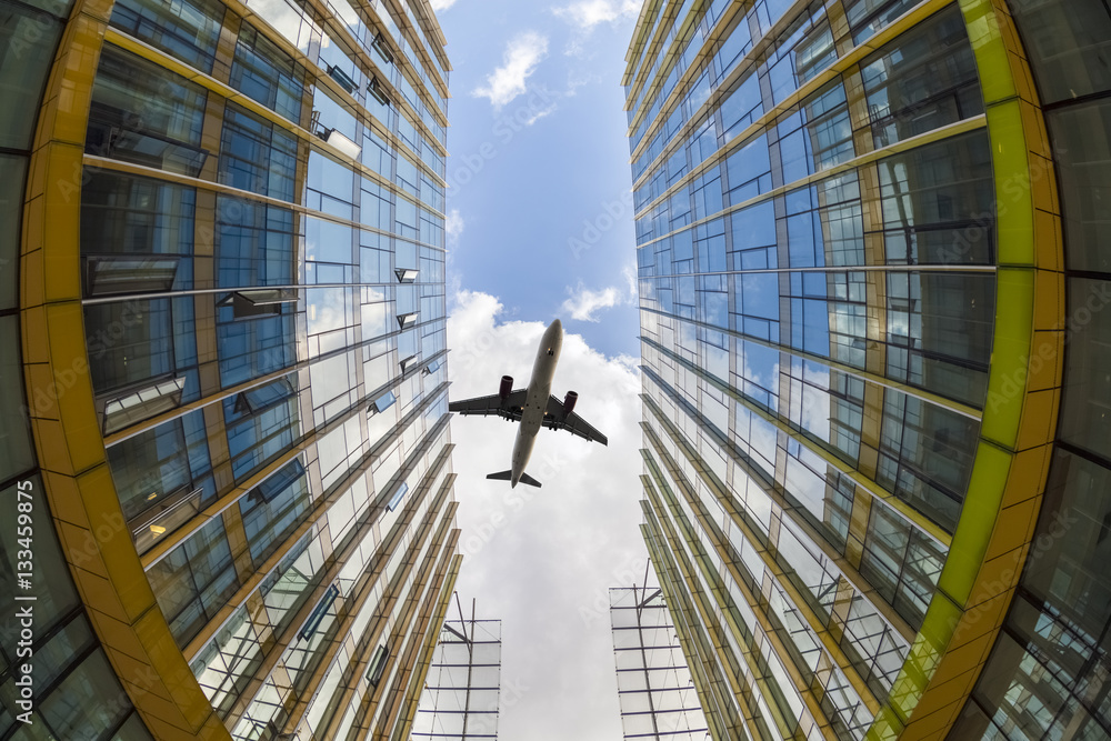 modern glass buildings and airplane