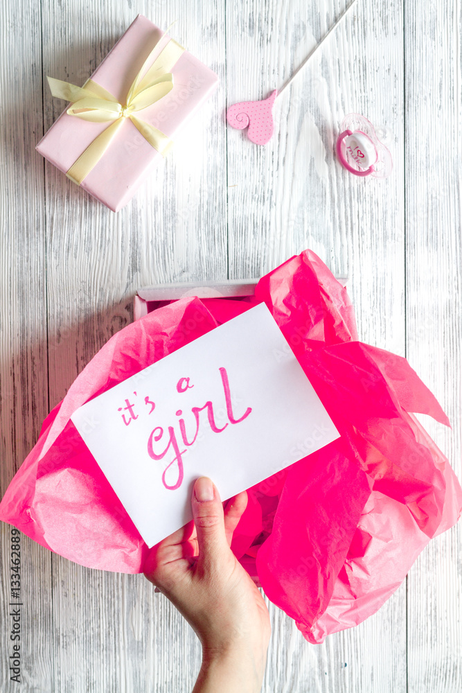 birth of girl - baby shower concept on wooden background