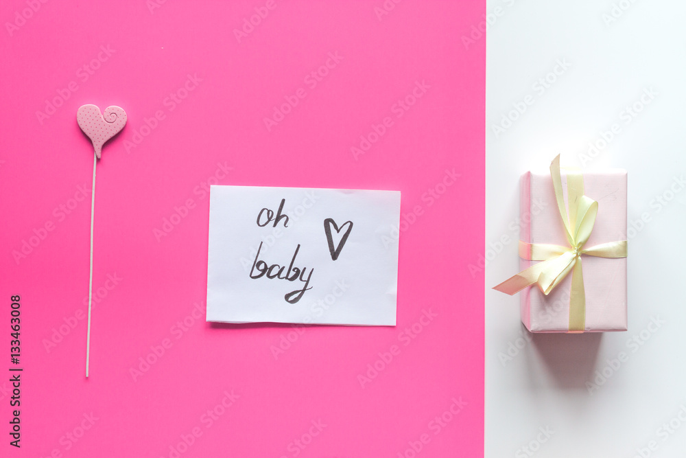 babys bootees and gift box on wooden background