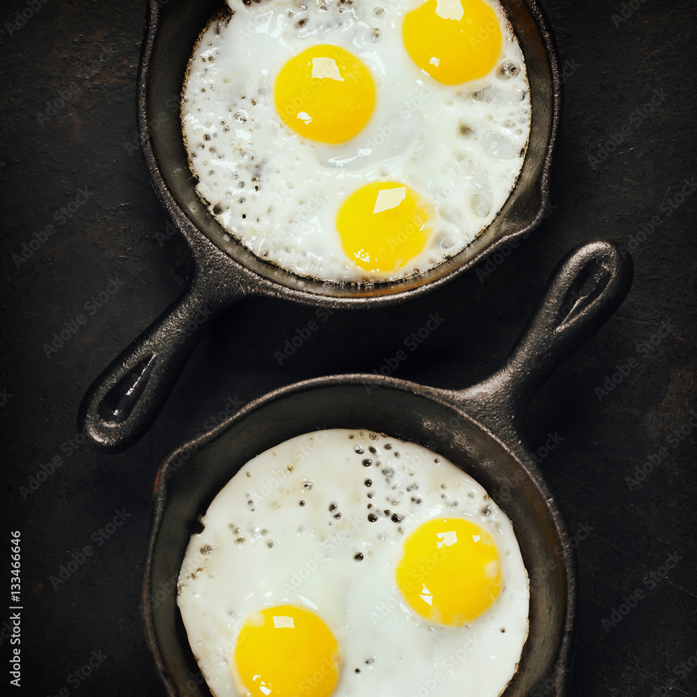 Pans with fried eggs