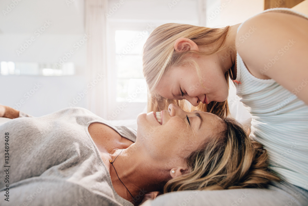 Loving mother and daughter in bedroom