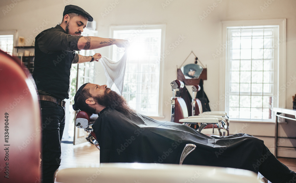 Barber taking care of client in barbershop