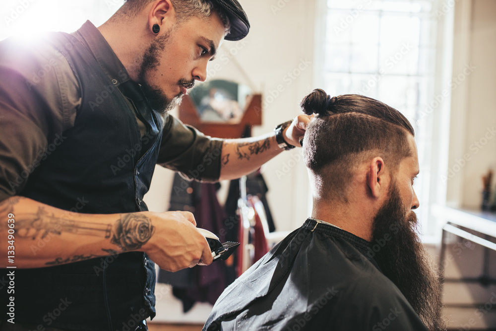 Beard man getting haircut at salon