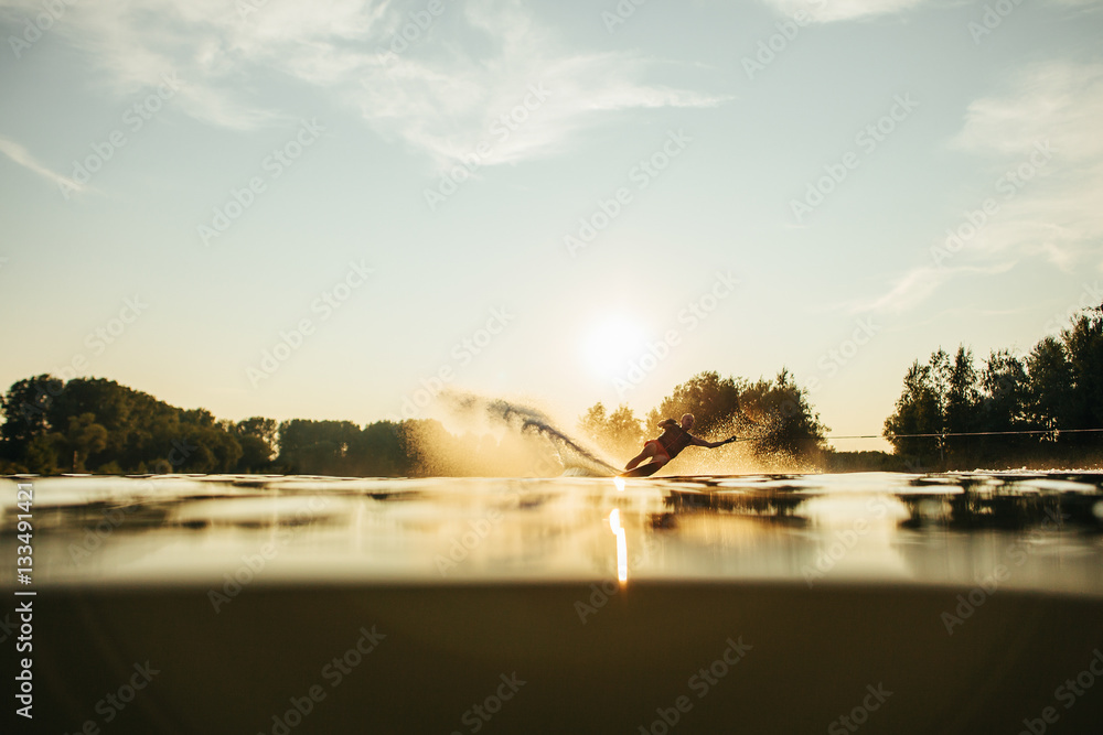 Man water skiing at sunset