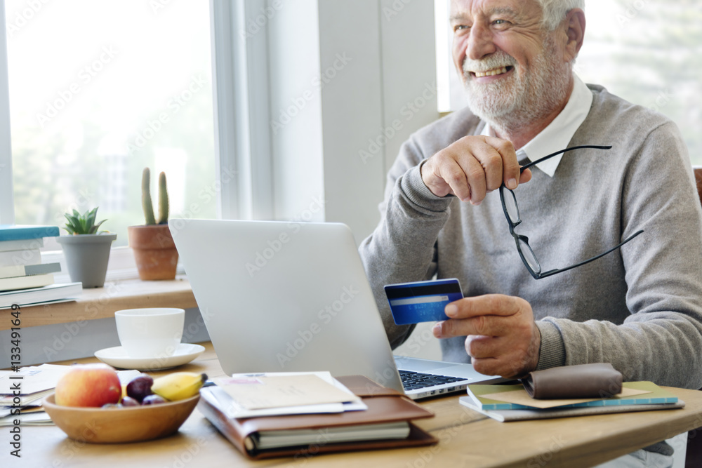 Senior Adult Holding Credit Card Concept