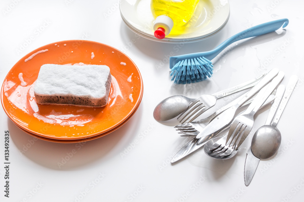 concept of washing dishes on white background top view