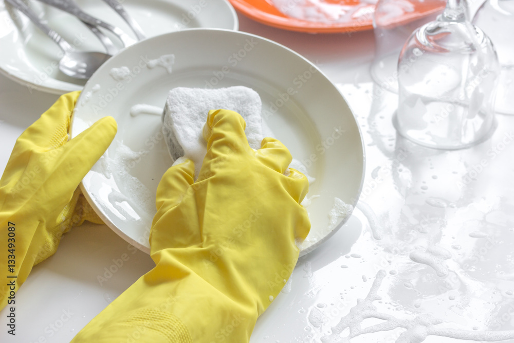 concept of woman washing dishes on white background