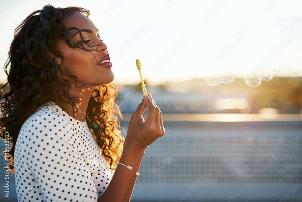 Attractive woman blowing bubbles