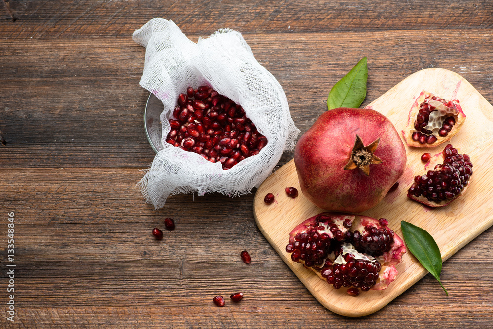 Pomegranate fruits with grains on wooden table. Top view. Make  juice.