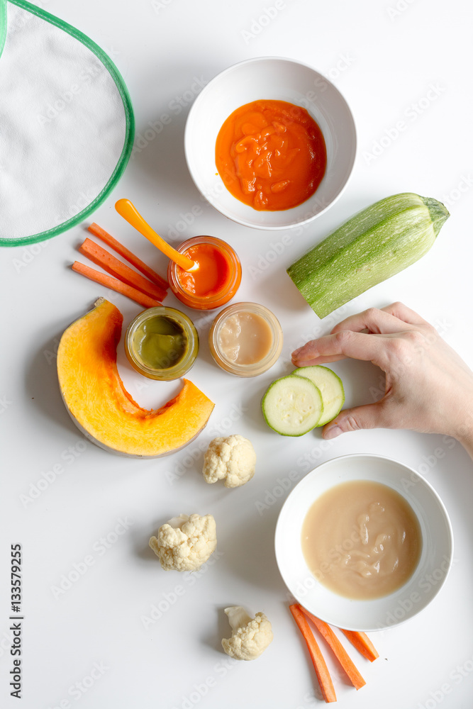 cooking vegetable puree for baby on white background top view