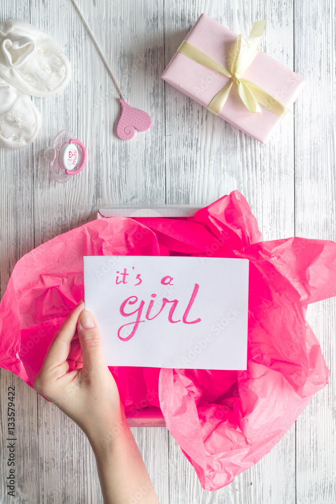 birth of girl - baby shower concept on wooden background