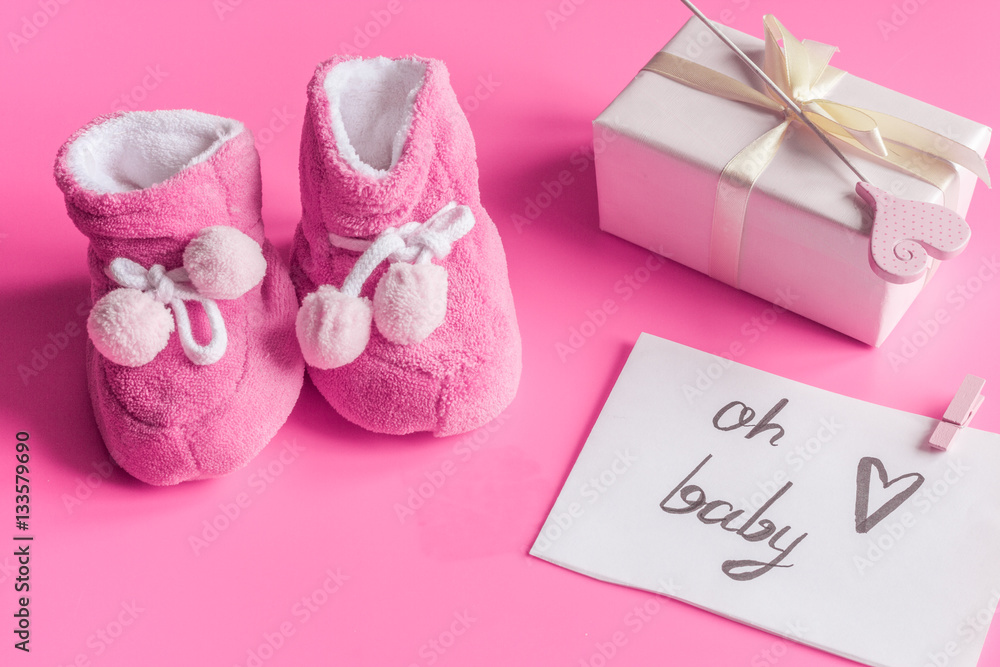 babys bootees and gift box on wooden background