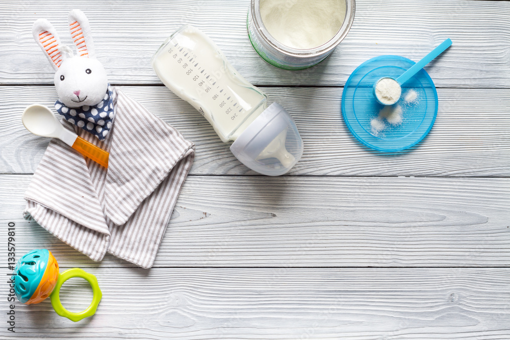 preparation of mixture baby feeding on wooden background top view