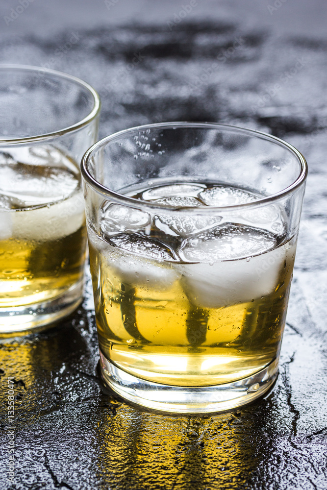 glass of whiskey on dark background