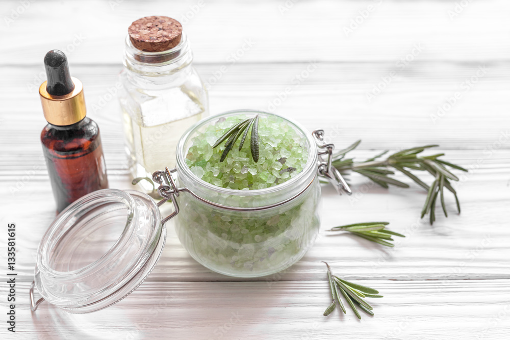 organic cosmetics with extracts of herbs rosemary on wooden background