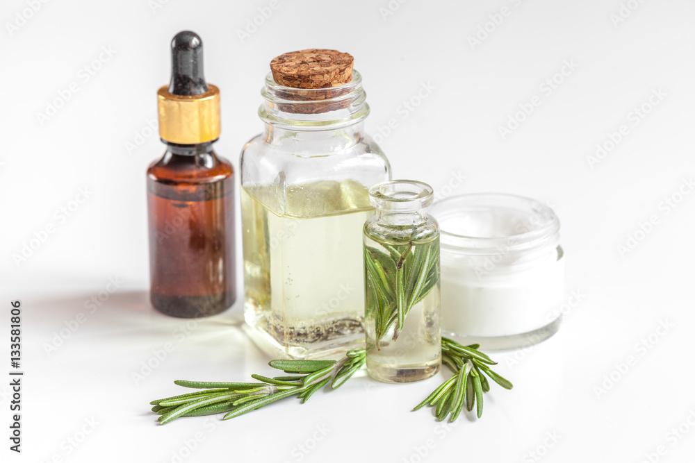 organic cosmetics with extracts of herbs rosemary on white background