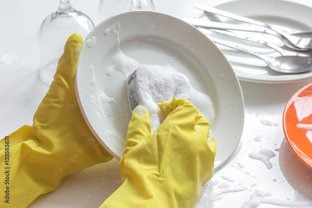 concept of woman washing dishes on white background