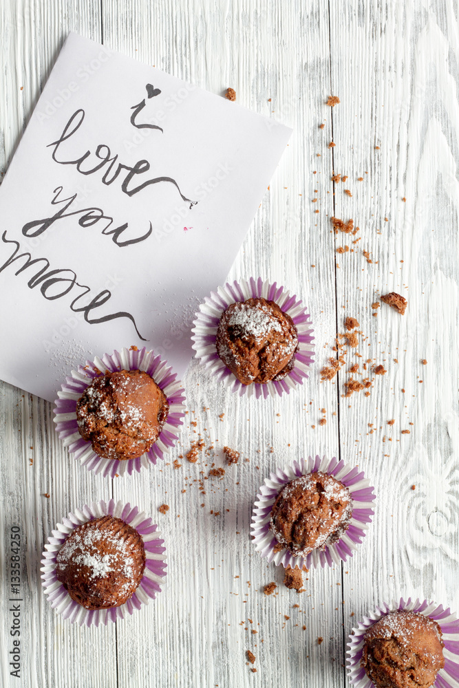 concept of Valentines Day cupcakes wooden background top view