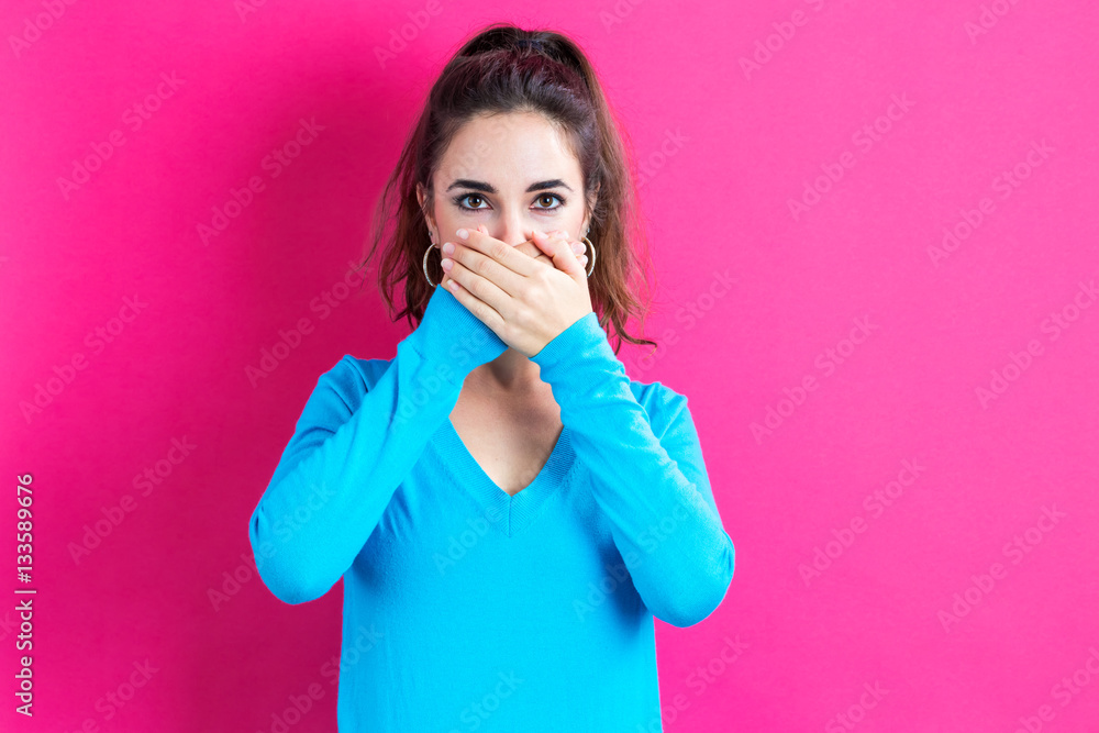 Young woman covering her mouth