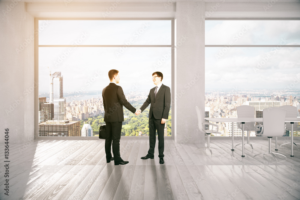 People shaking hands in meeting room