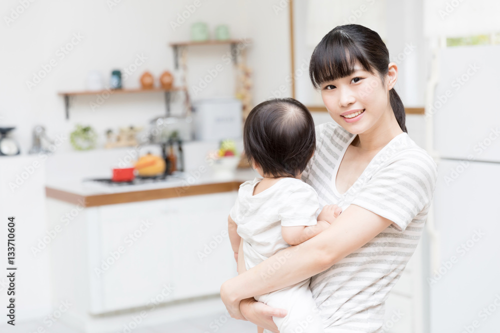 portrait of asian mother and baby in the kitchen