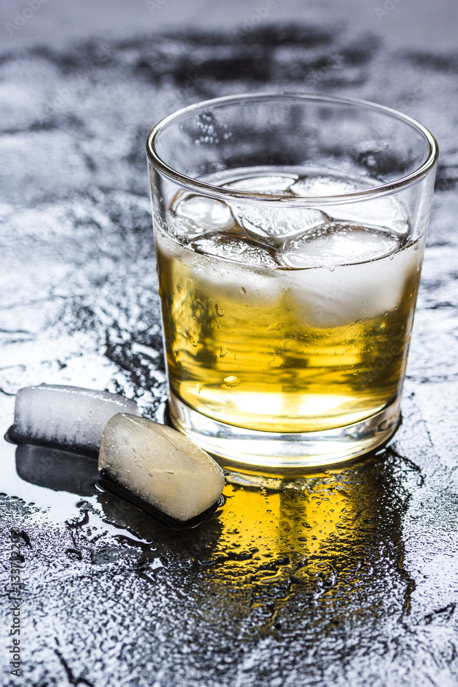 glass of whiskey on dark background