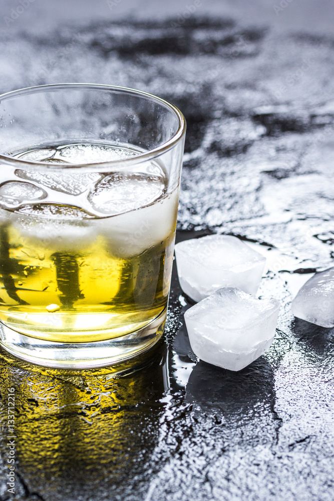 glass of whiskey on dark background