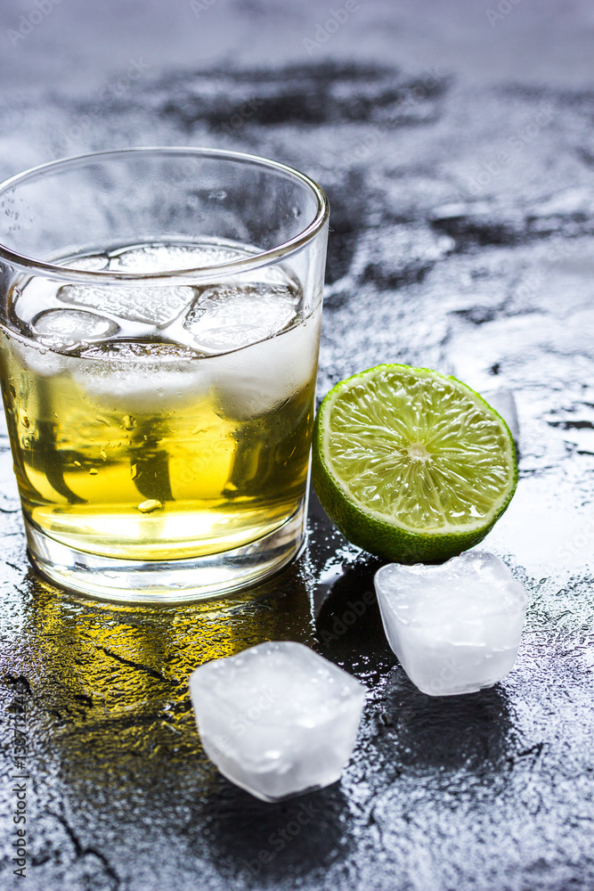 glass of whiskey on dark background