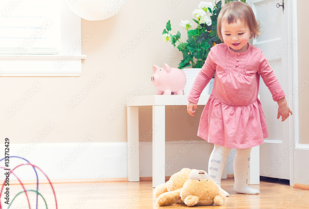 Happy toddler girl playing with toys