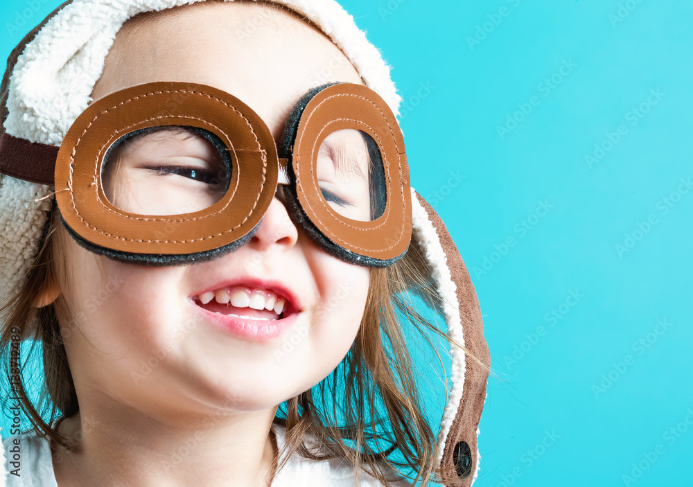 Toddler girl playing in pilot glasses