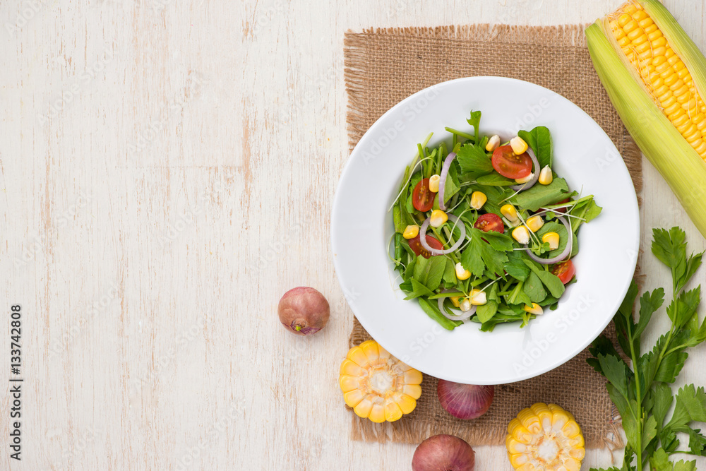 Homemade fresh green vegetable salad on table.