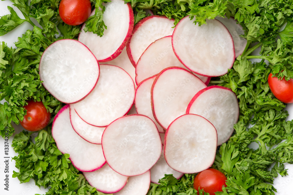 Homemade fresh radishes vegetable salad on table. Close-up.