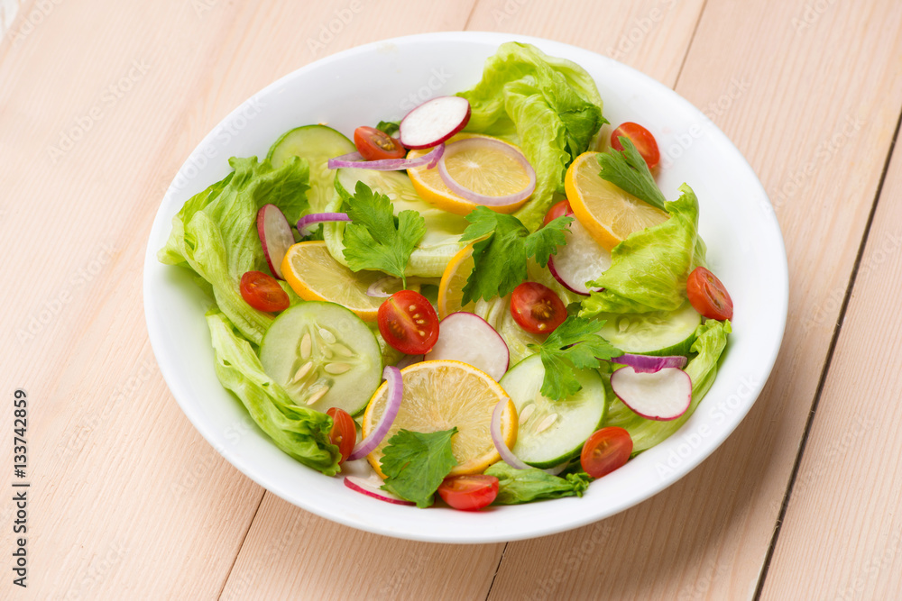 Homemade fresh green vegetable salad on table.