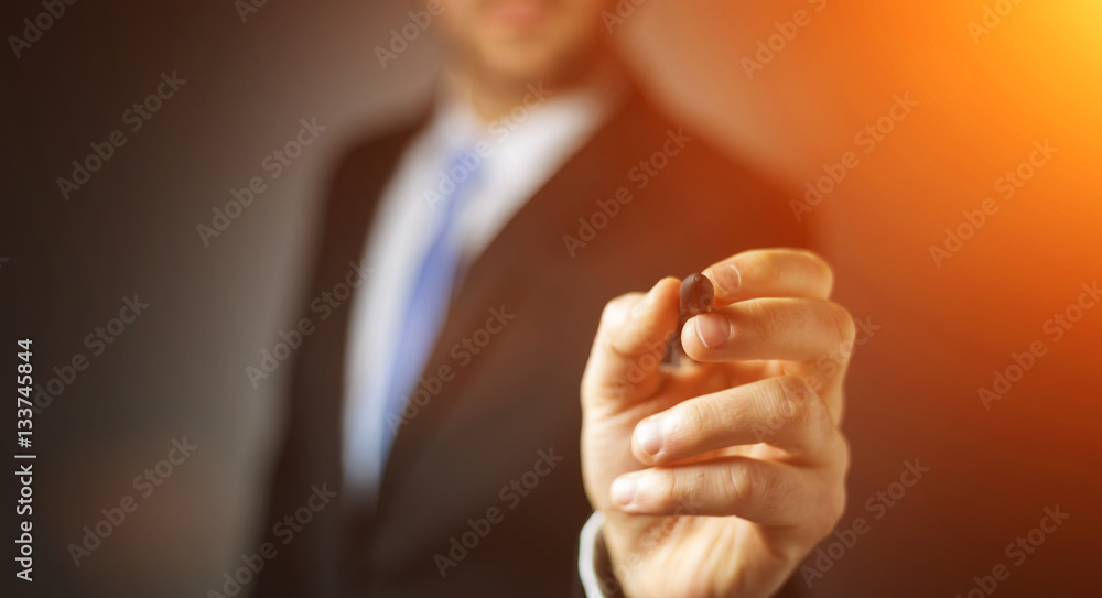 Businessman writing with a pen on a digital screen