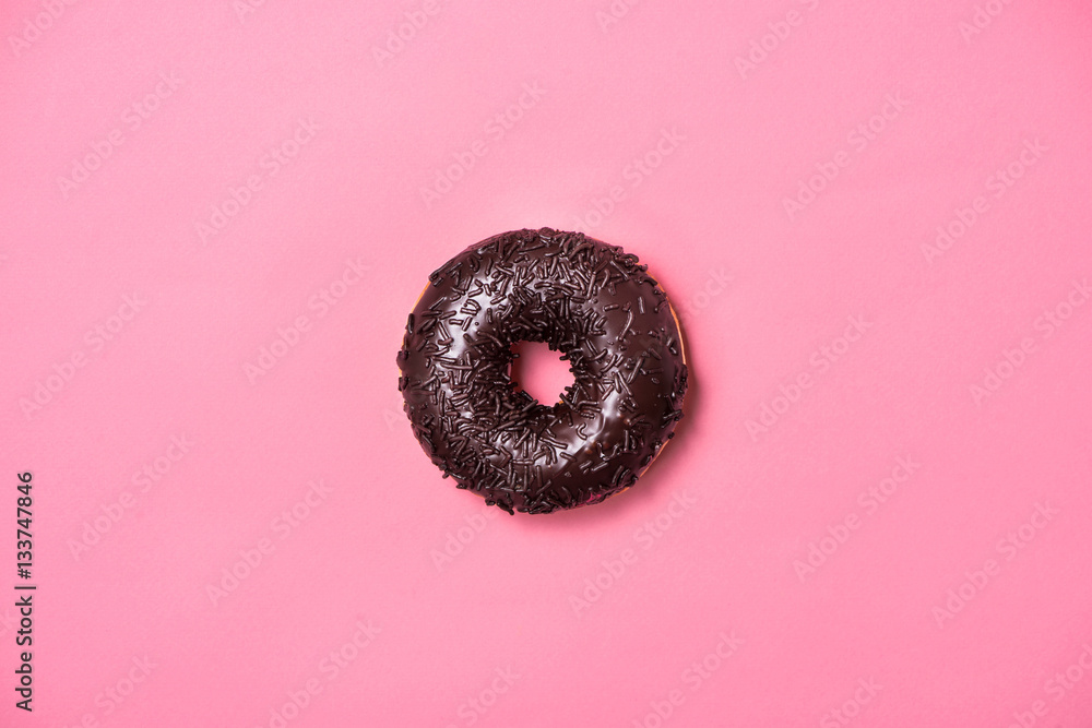 Donuts with icing on pastel pink background. Sweet donuts.