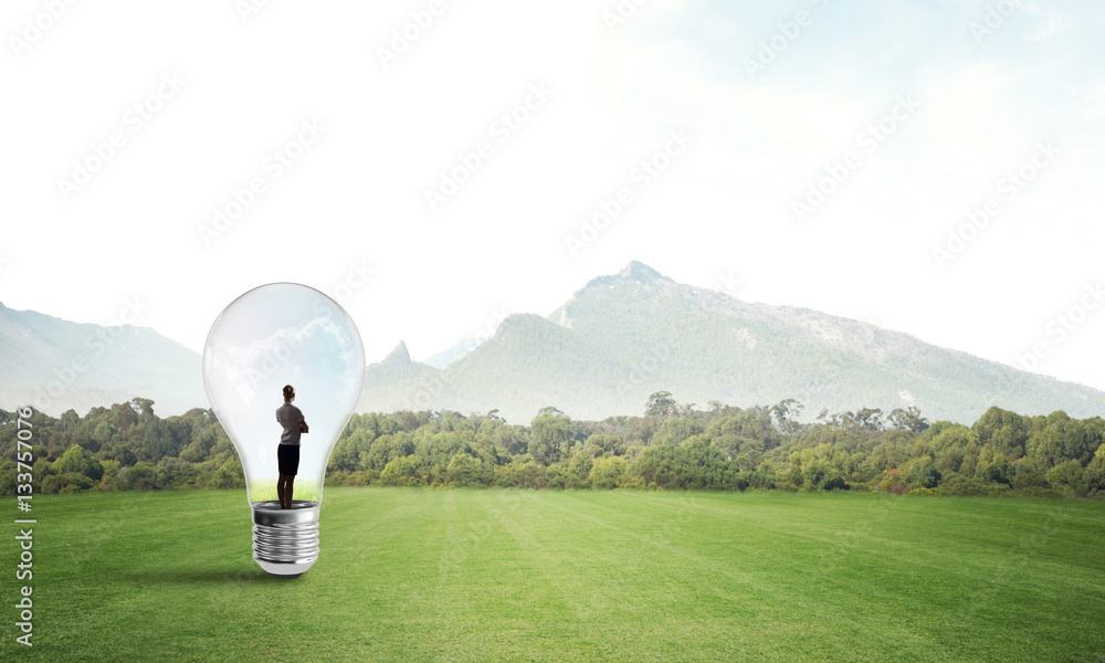 Businesswoman inside light bulb