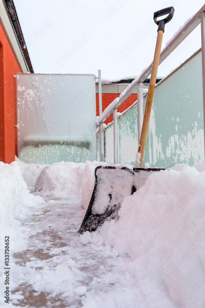 Snow shovel on the balcony after winter snowfall