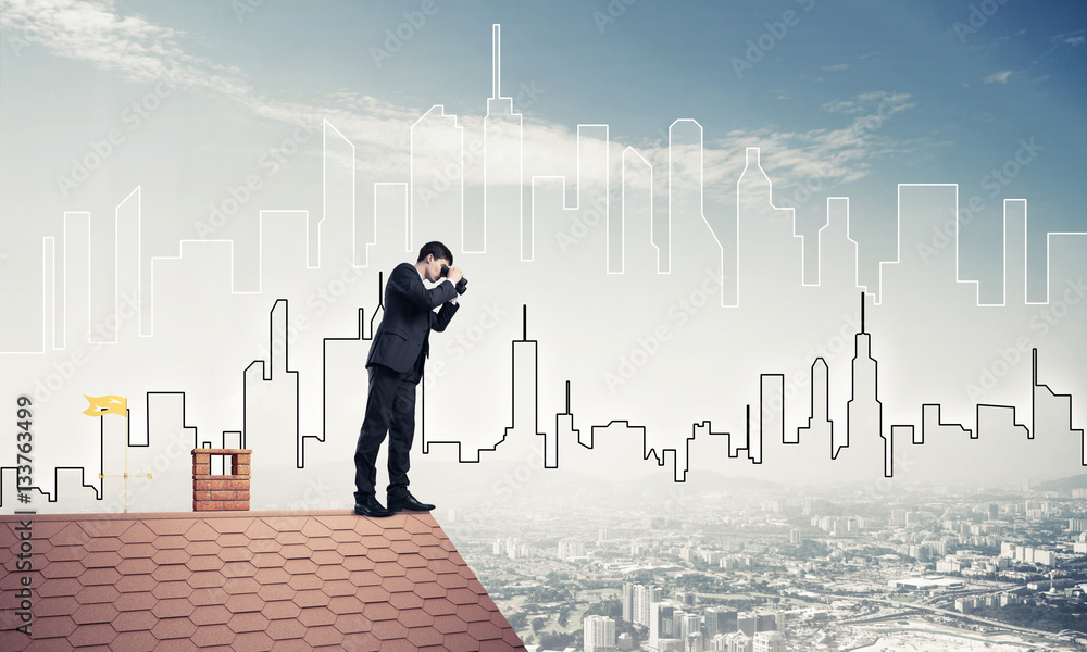 Businessman standing on roof and looking in binoculars. Mixed me