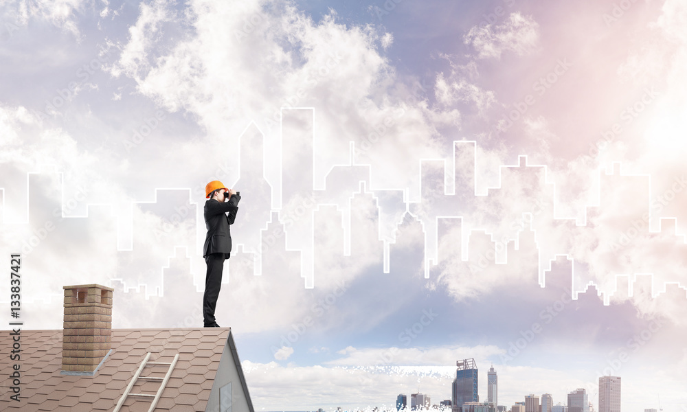 Engineer man standing on roof and looking in binoculars. Mixed media