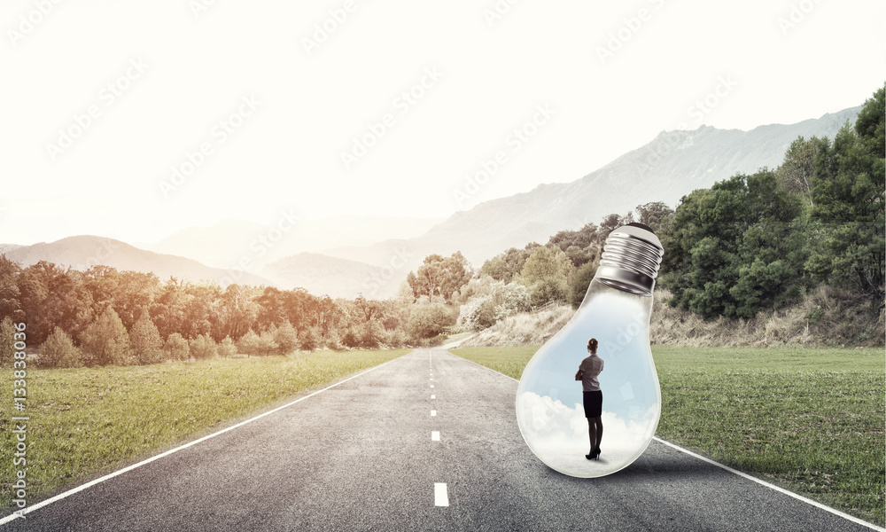 Businesswoman inside light bulb