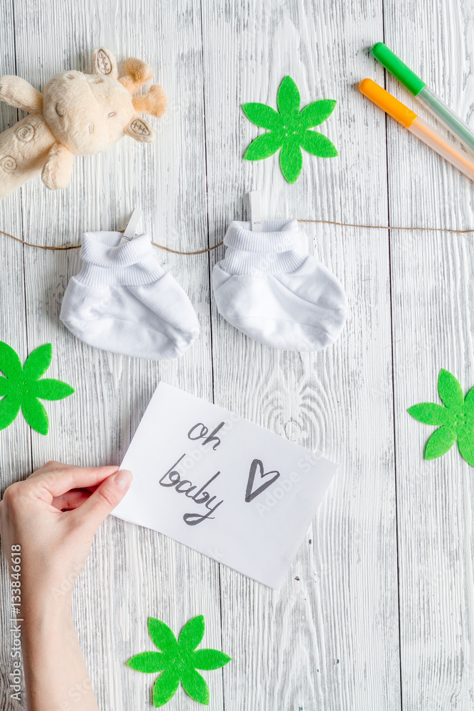 birth of child - baby shower concept on wooden background