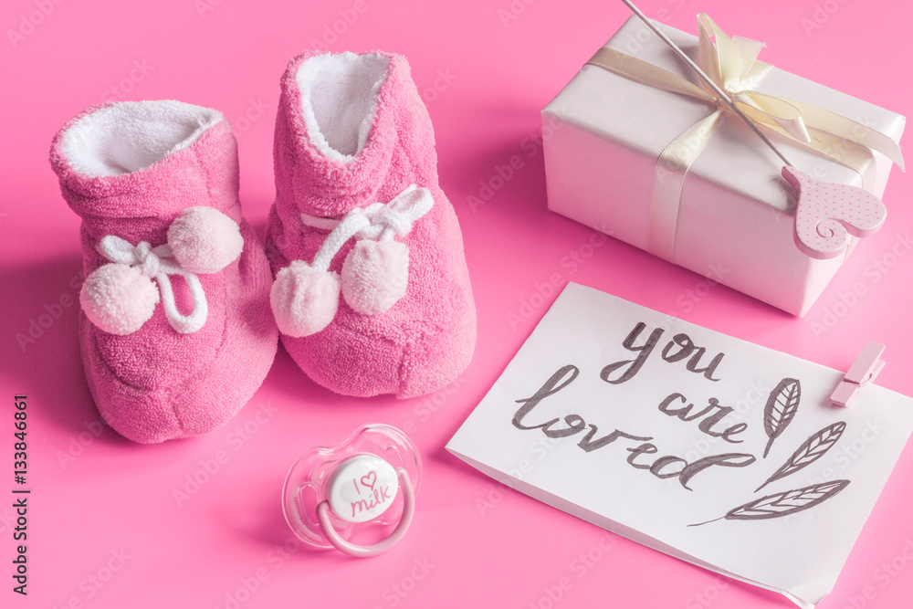 babys bootees and gift box on wooden background