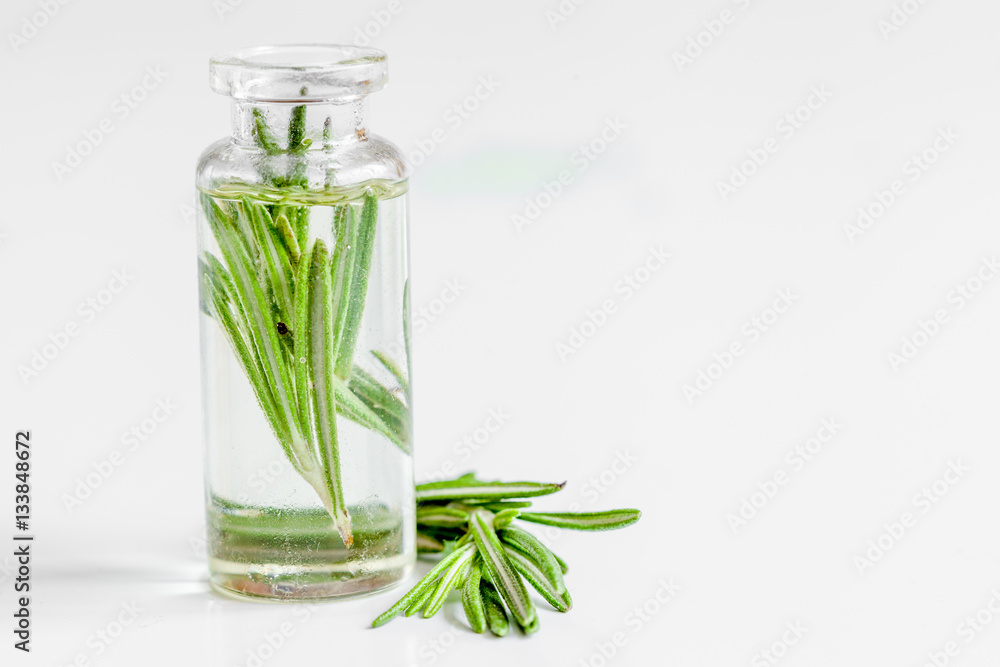 organic cosmetics with extracts of herbs rosemary on white background