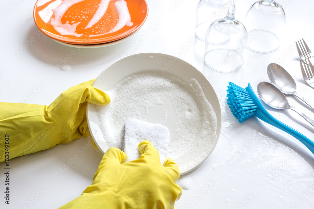 concept of woman washing dishes on white background