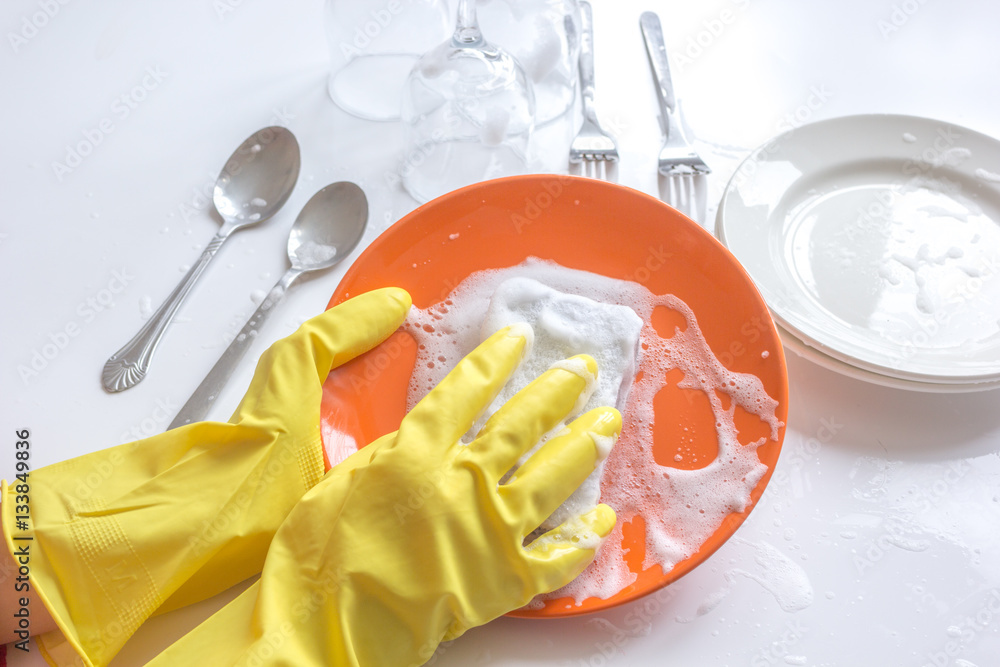 concept of woman washing dishes on white background