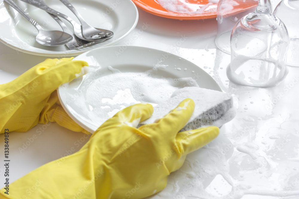 concept of woman washing dishes on white background